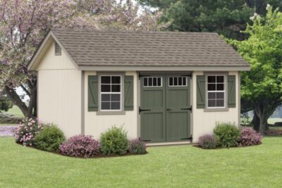 classic garden cottage with tan siding and green doors and trim