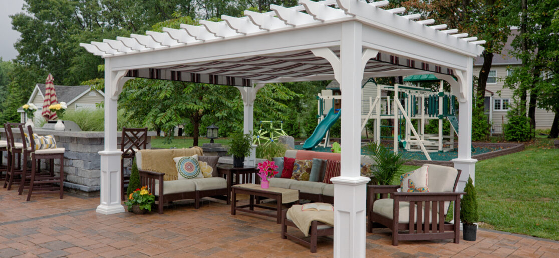 white vinyl pergola over an outdoor sitting area
