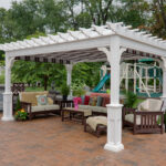 white vinyl pergola over an outdoor sitting area