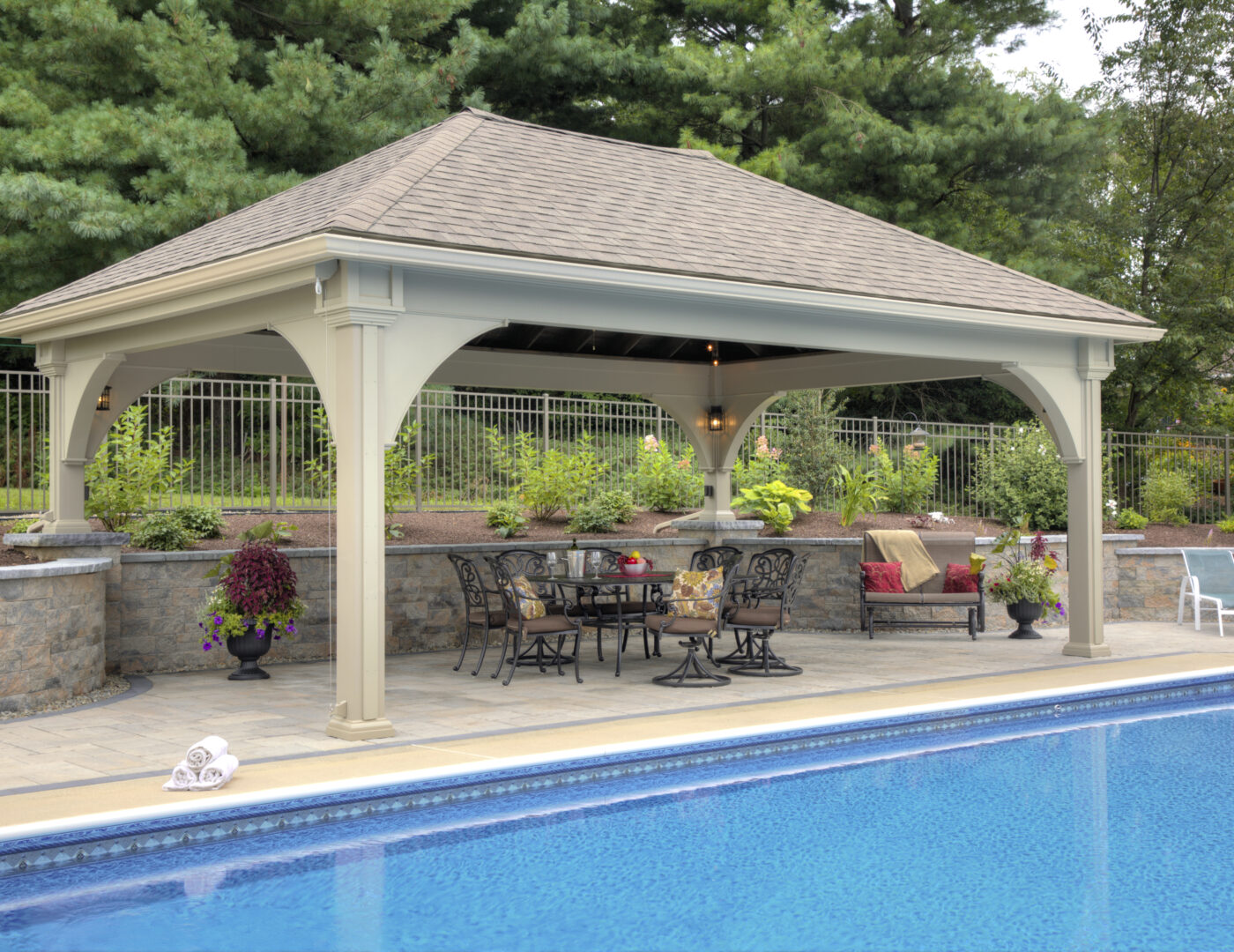 vinyl grand estate pavilion next to a pool