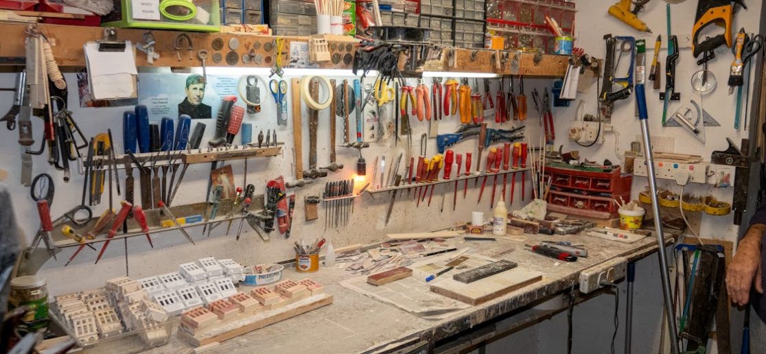 shed workshop with various tools hanging on the wall and a workbench