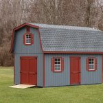 elite classic dutch barn shed with blue siding and red doors and shutters