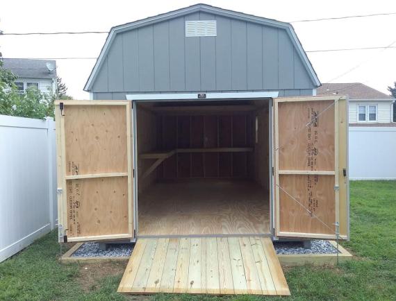 dutch barn shed with the double doors wide open with a ramp